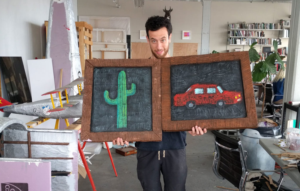 Eamon Monaghan with prop paintings in his studio in Sunset Park
